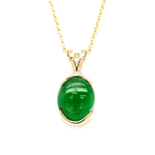 Beautiful jade pendant featuring a delicate design, set in 10K yellow gold, showcasing the vibrant green color and unique patterns of the jade stone