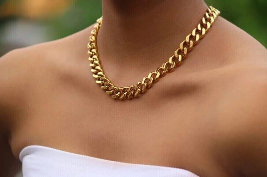 Woman elegantly adorned with a delicate gold chain necklace, showcasing a timeless style and sophistication